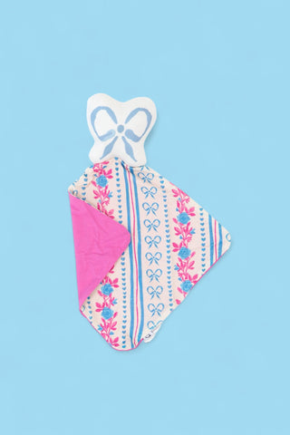 Soft plush lovey with white bow-shaped head and patterned fabric body featuring pink flowers, blue bows, and dots with bright