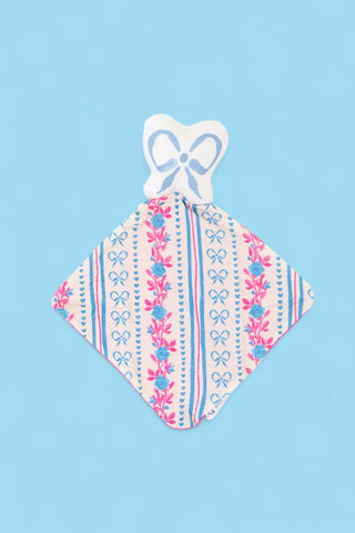Soft plush lovey with white bow-shaped head and diamond-shaped body featuring pink floral and blue bow print pattern.